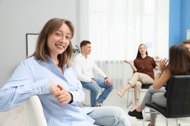 Photo of Group of people having meeting during life coaching class indoors, selective focus