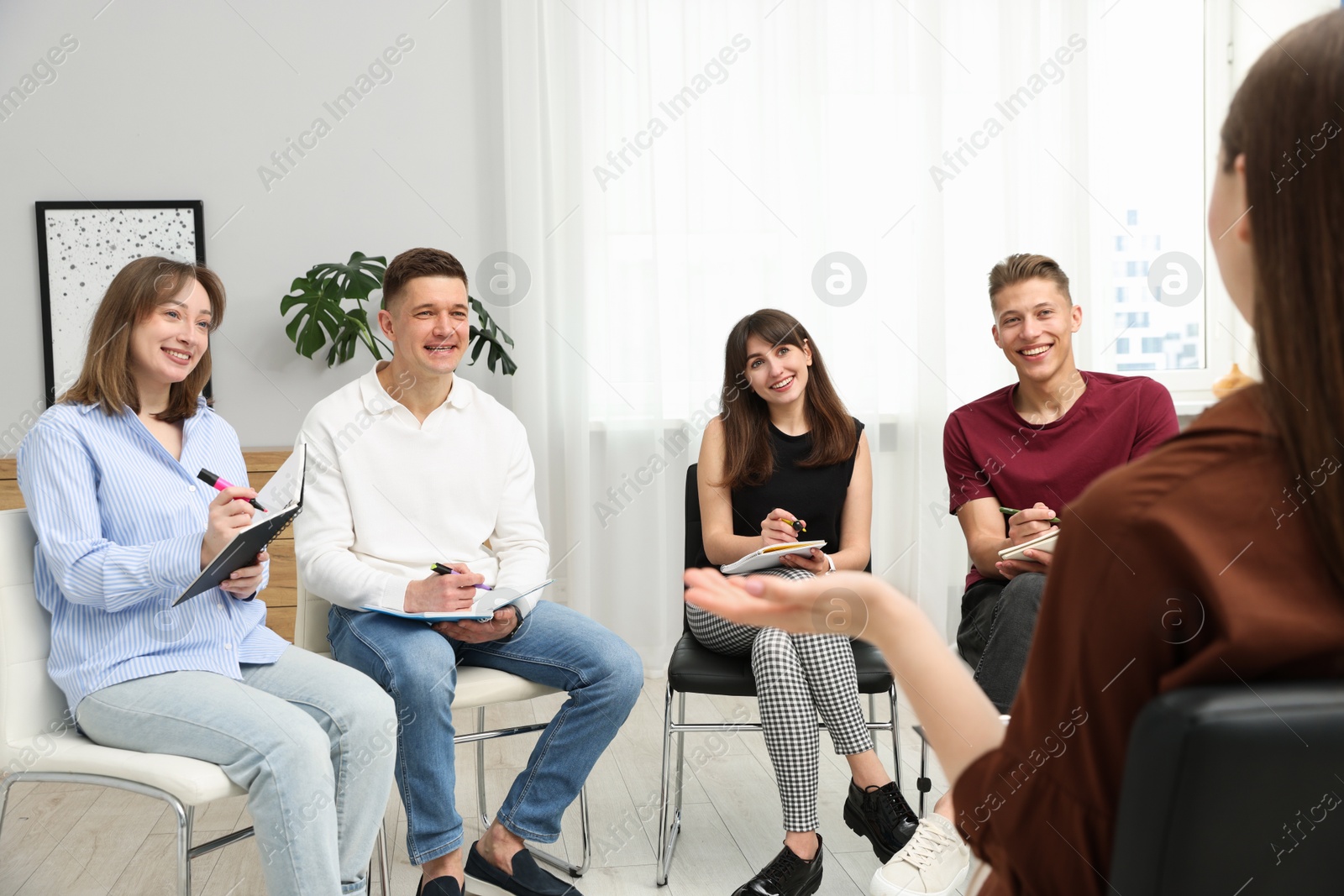 Photo of Group of people having meeting during life coaching class indoors