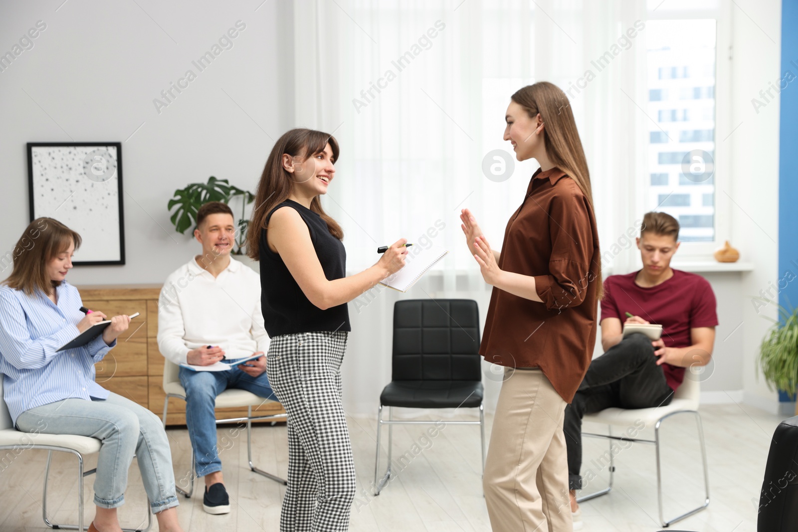 Photo of Group of people having meeting during life coaching class indoors