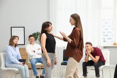 Photo of Group of people having meeting during life coaching class indoors