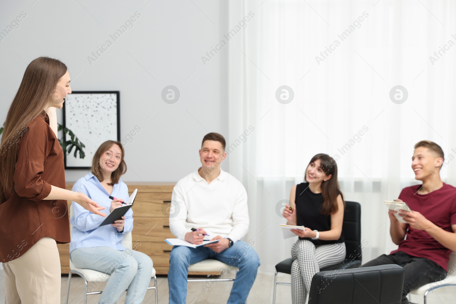 Photo of Group of people having meeting during life coaching class indoors