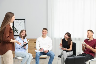 Photo of Group of people having meeting during life coaching class indoors