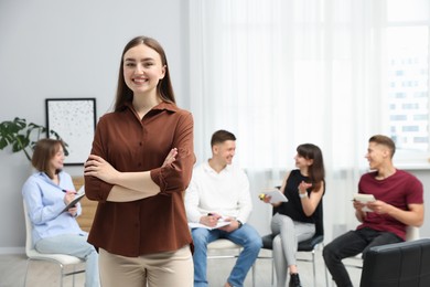 Photo of Group of people having meeting during life coaching class indoors, selective focus