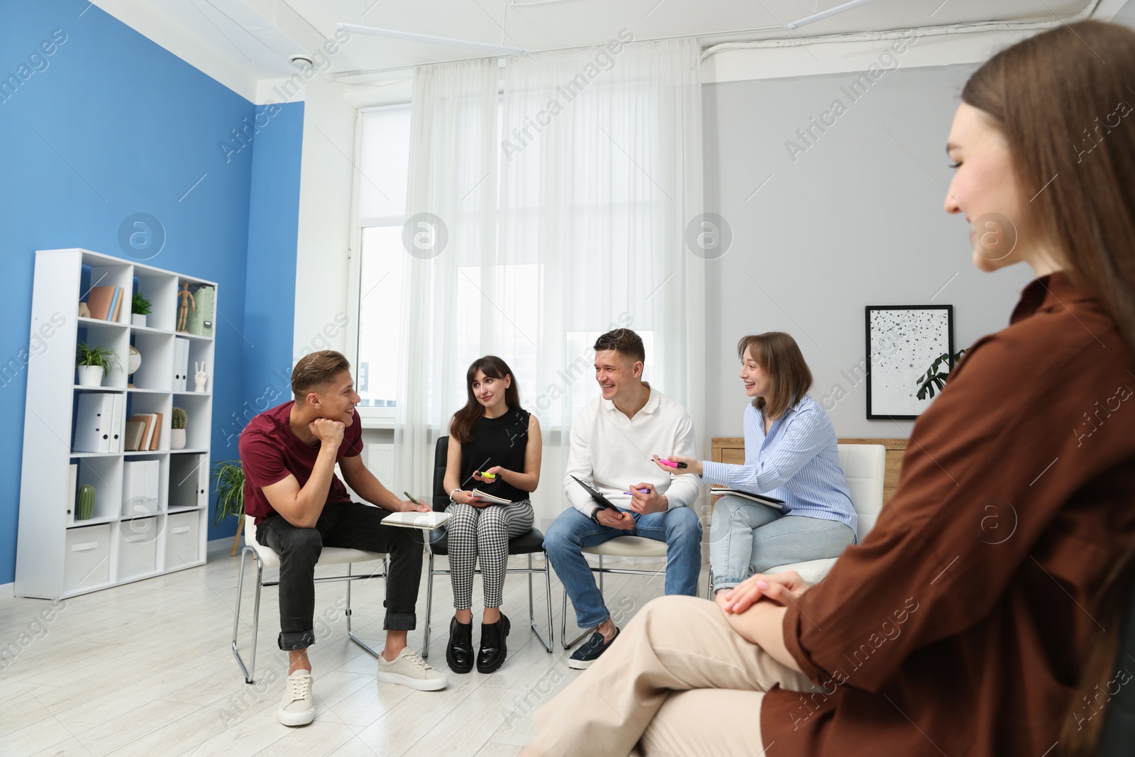 Photo of Group of people having meeting during life coaching class indoors
