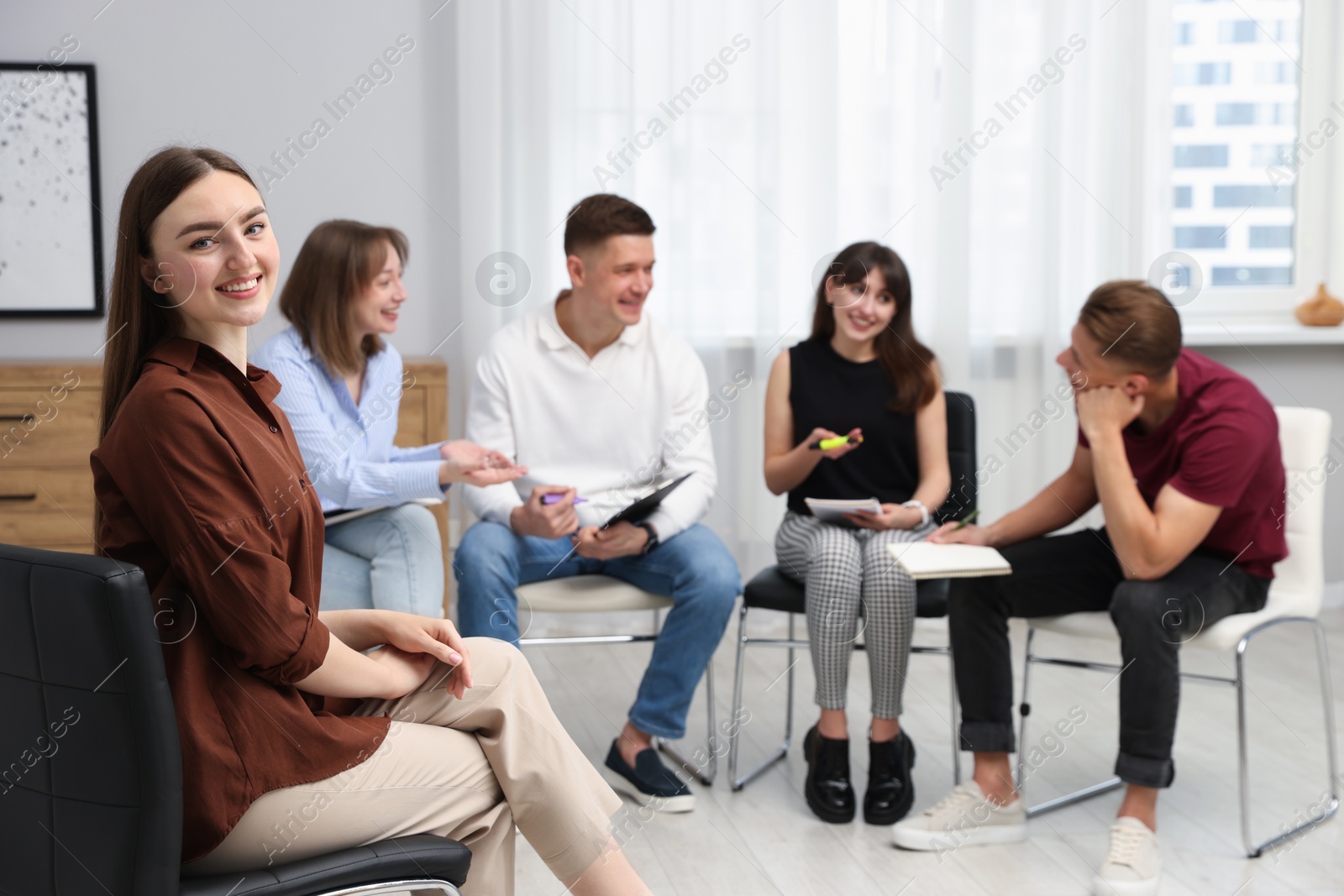 Photo of Group of people having meeting during life coaching class indoors