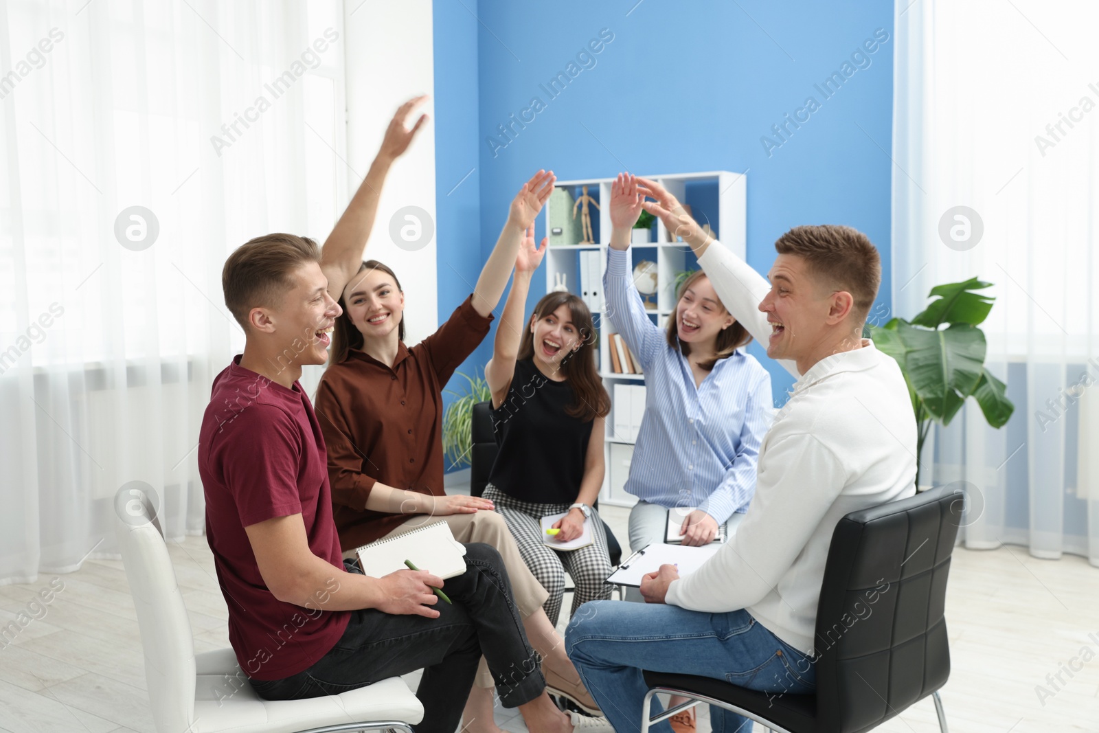 Photo of Group of people having meeting during life coaching class indoors