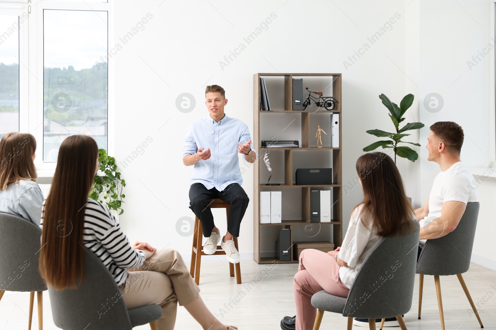 Photo of Group of people having meeting during life coaching class indoors