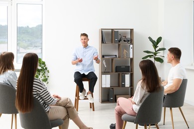 Photo of Group of people having meeting during life coaching class indoors