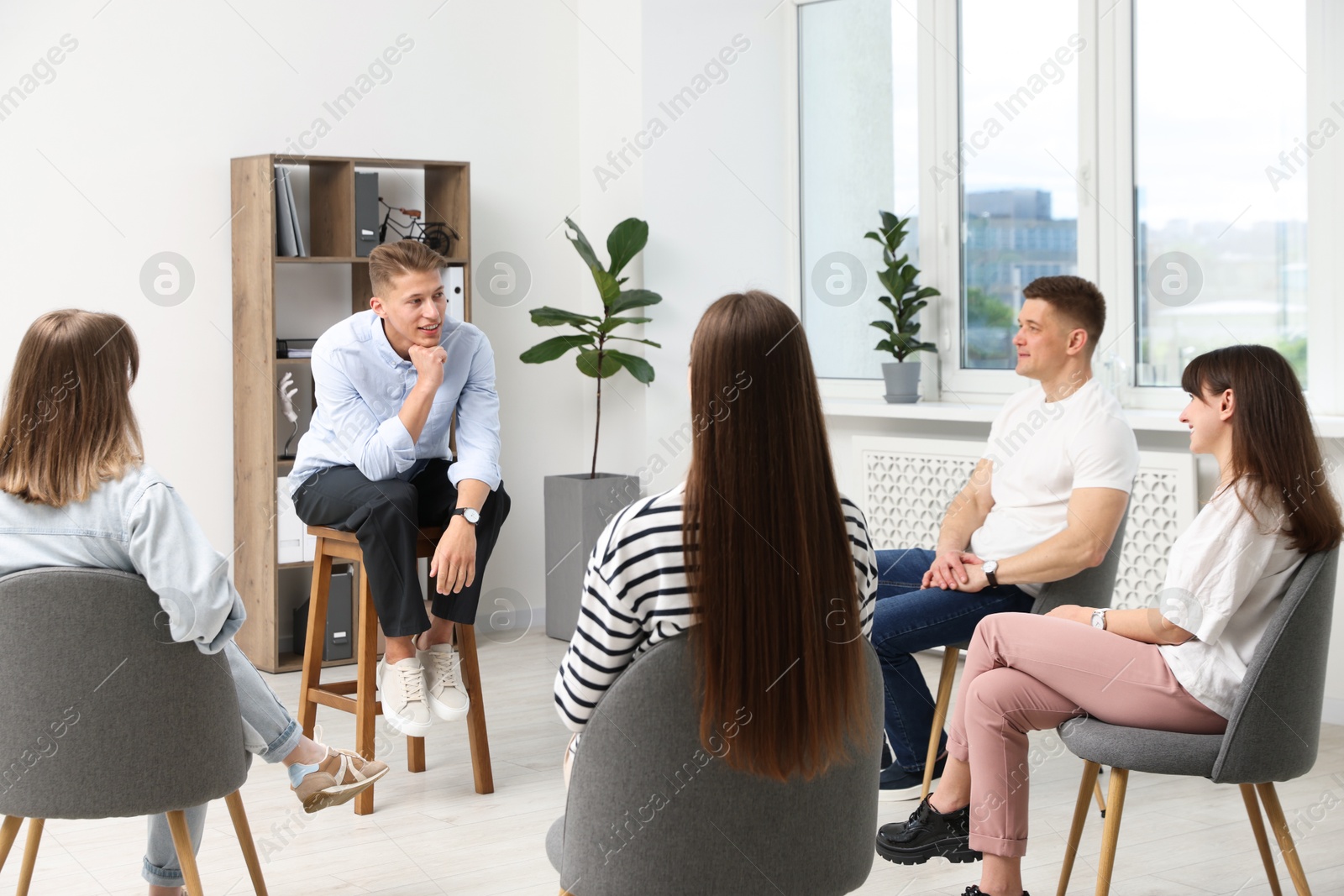 Photo of Group of people having meeting during life coaching class indoors