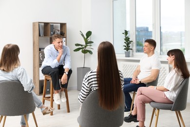 Photo of Group of people having meeting during life coaching class indoors