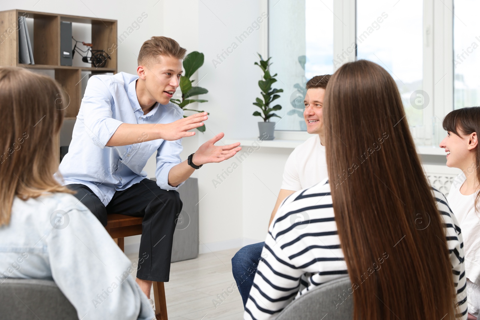 Photo of Group of people having meeting during life coaching class indoors