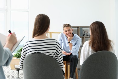 Photo of Group of people having meeting during life coaching class indoors