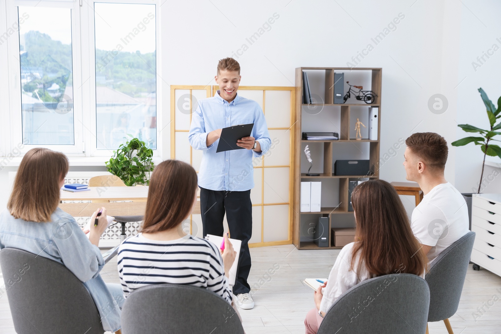 Photo of Group of people having meeting during life coaching class indoors