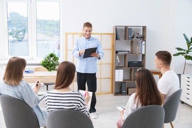 Photo of Group of people having meeting during life coaching class indoors
