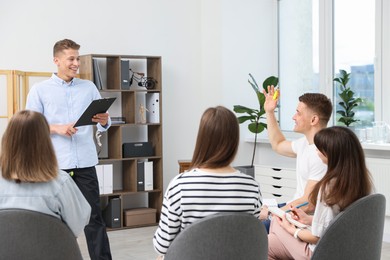 Photo of Group of people having meeting during life coaching class indoors