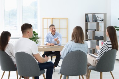 Photo of Group of people having meeting during life coaching class indoors