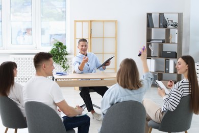 Photo of Group of people having meeting during life coaching class indoors
