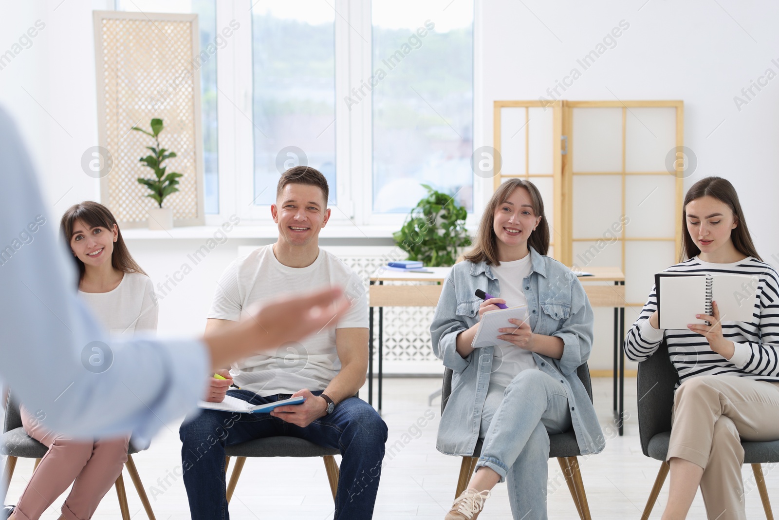 Photo of Group of people having meeting during life coaching class indoors