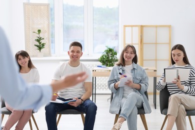 Photo of Group of people having meeting during life coaching class indoors