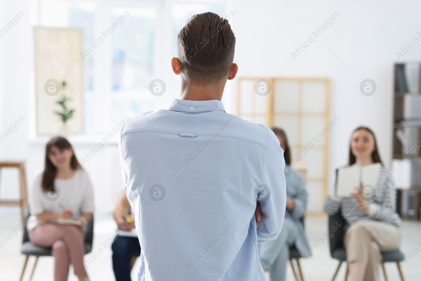 Photo of Group of people having meeting during life coaching class indoors, selective focus
