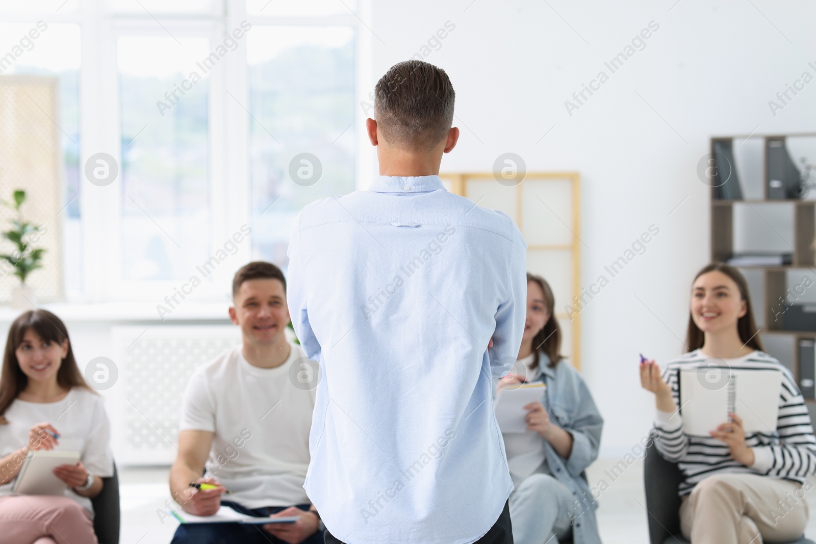 Photo of Group of people having meeting during life coaching class indoors, selective focus
