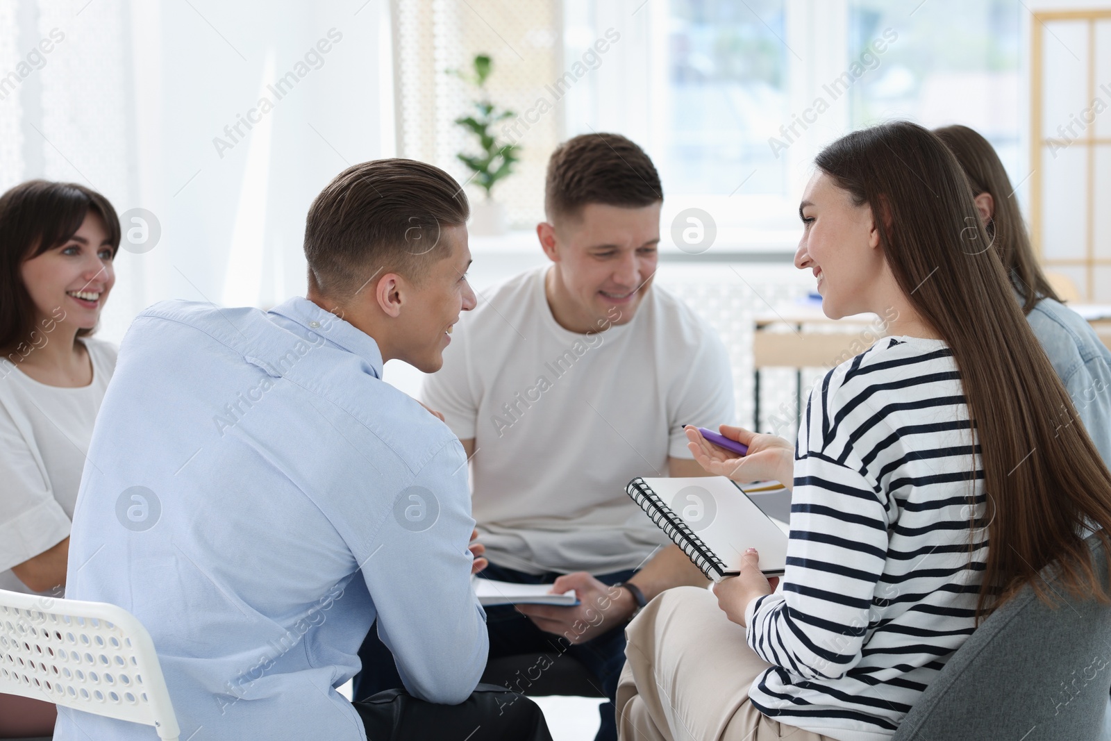 Photo of Group of people having meeting during life coaching class indoors