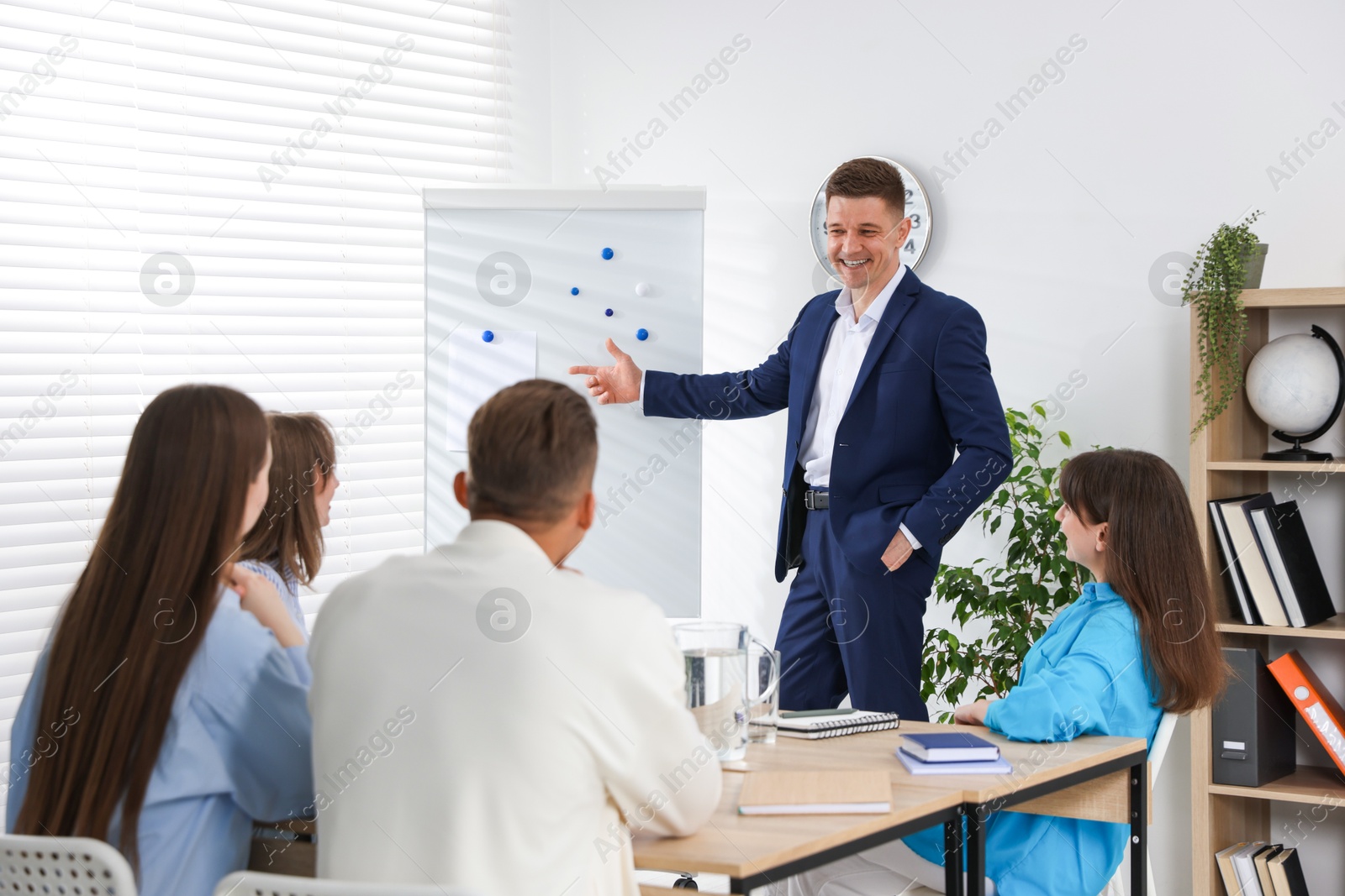 Photo of Group of people having meeting during life coaching class indoors