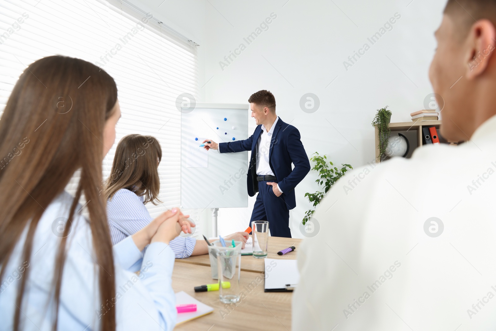 Photo of Group of people having meeting during life coaching class indoors