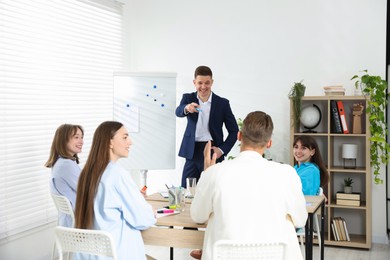 Photo of Group of people having meeting during life coaching class indoors