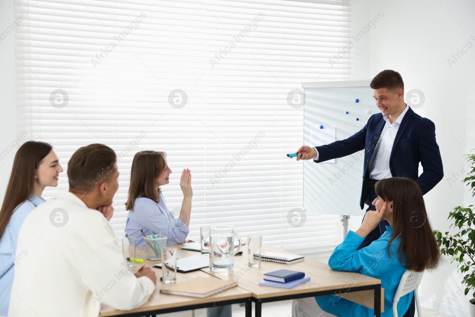 Photo of Group of people having meeting during life coaching class indoors