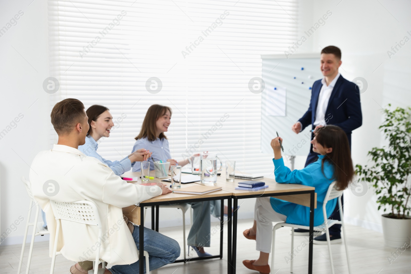 Photo of Group of people having meeting during life coaching class indoors, selective focus