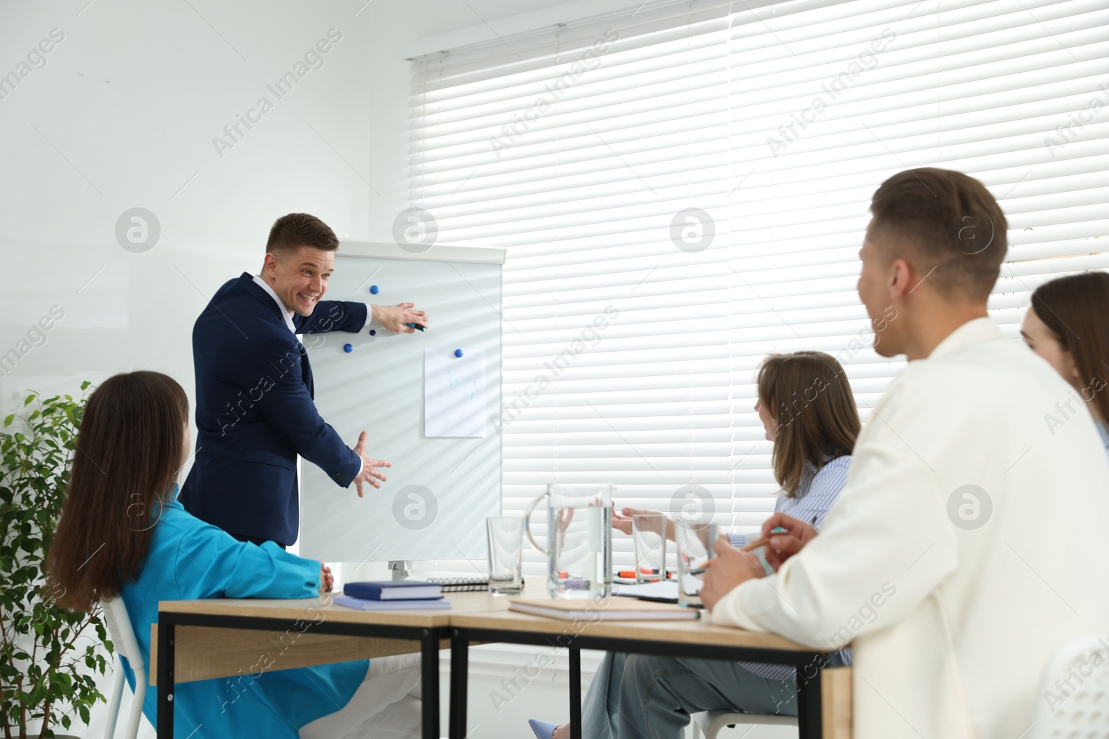 Photo of Group of people having meeting during life coaching class indoors