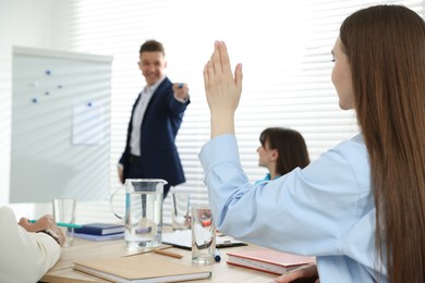 Photo of Group of people having meeting during life coaching class indoors, selective focus