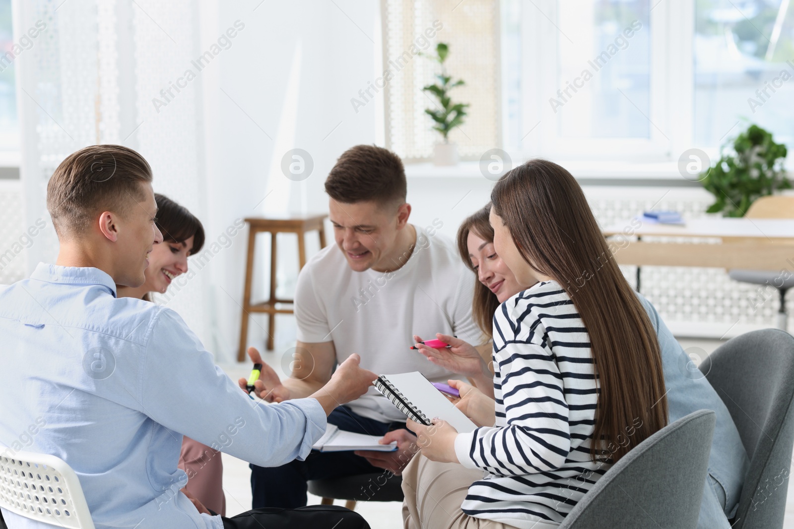Photo of Group of people having meeting during life coaching class indoors