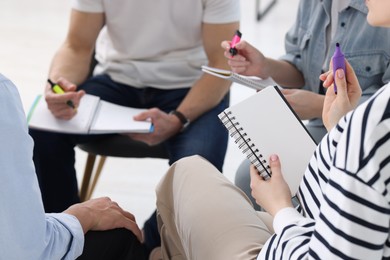 Photo of Group of people having meeting during life coaching class indoors, closeup