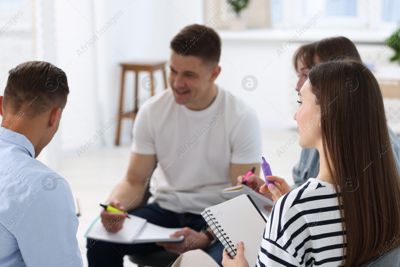 Photo of Group of people having meeting during life coaching class indoors