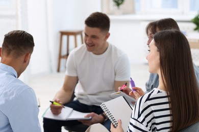 Photo of Group of people having meeting during life coaching class indoors