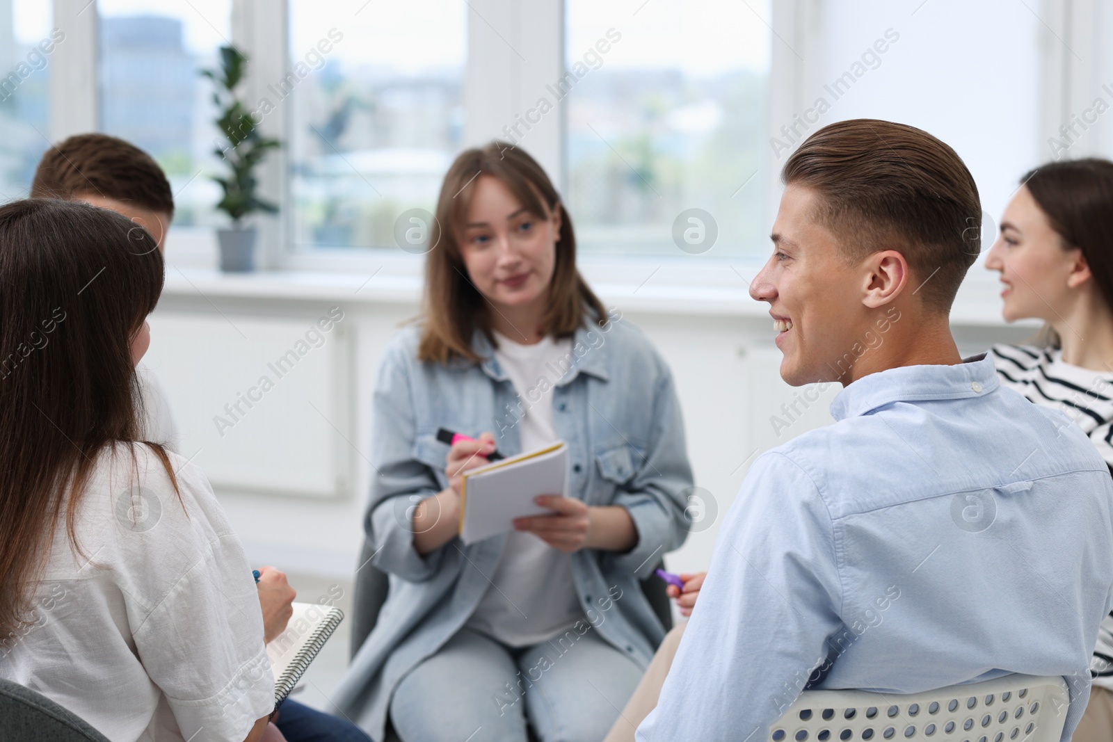 Photo of Group of people having meeting during life coaching class indoors