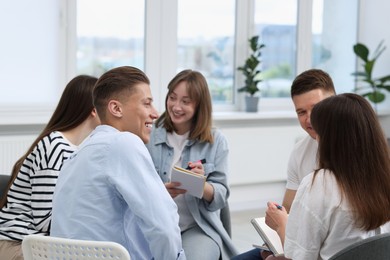 Photo of Group of people having meeting during life coaching class indoors