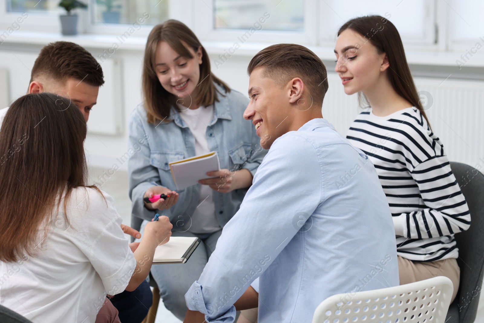 Photo of Group of people having meeting during life coaching class indoors