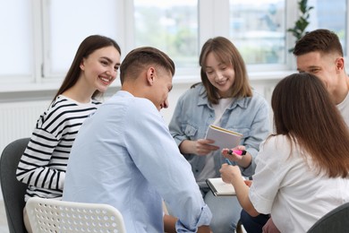 Photo of Group of people having meeting during life coaching class indoors