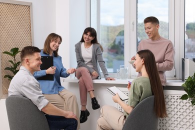 Photo of Group of people having meeting during life coaching class indoors