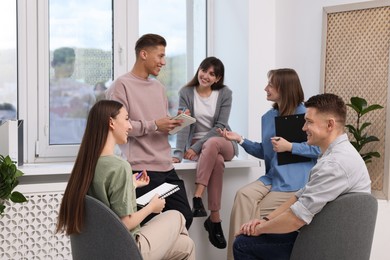 Photo of Group of people having meeting during life coaching class indoors