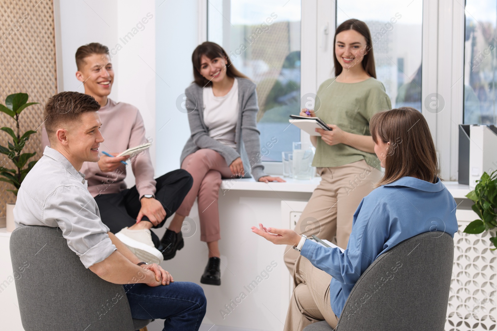 Photo of Group of people having meeting during life coaching class indoors
