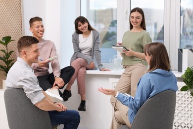 Photo of Group of people having meeting during life coaching class indoors
