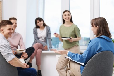 Photo of Group of people having meeting during life coaching class indoors