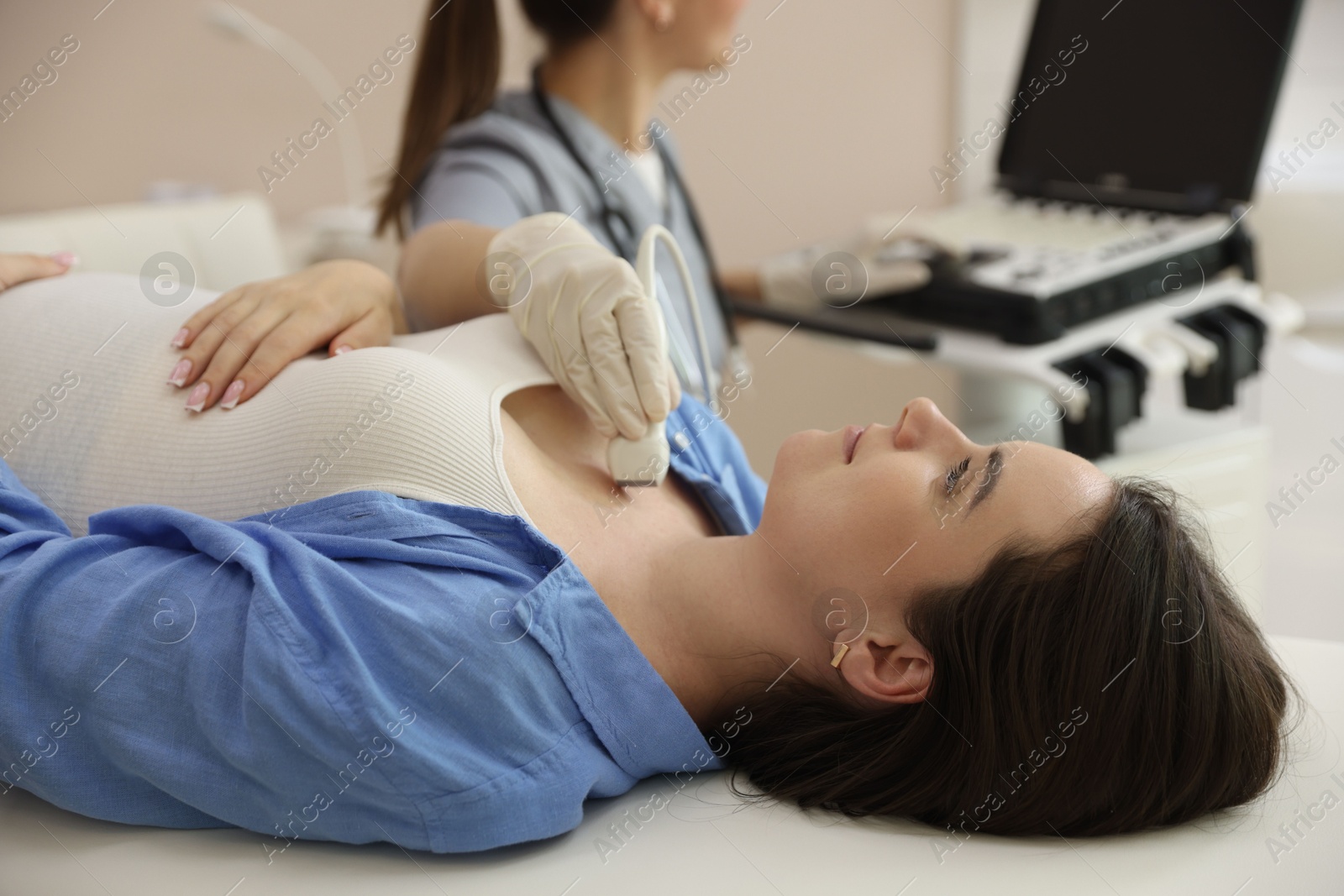 Sonographer conducting ultrasound examination of woman's thyroid gland in clinic, closeup Photo of Sonographer conducting ultrasound examination of woman's thyroid gland in clinic, closeup