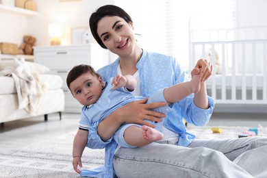 Photo of Mother with her cute baby at home
