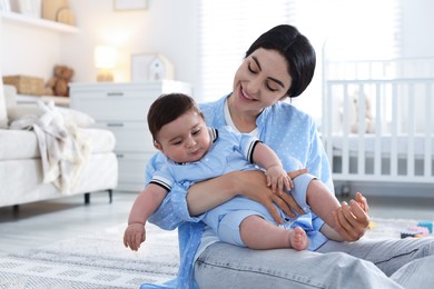 Photo of Mother with her cute baby at home