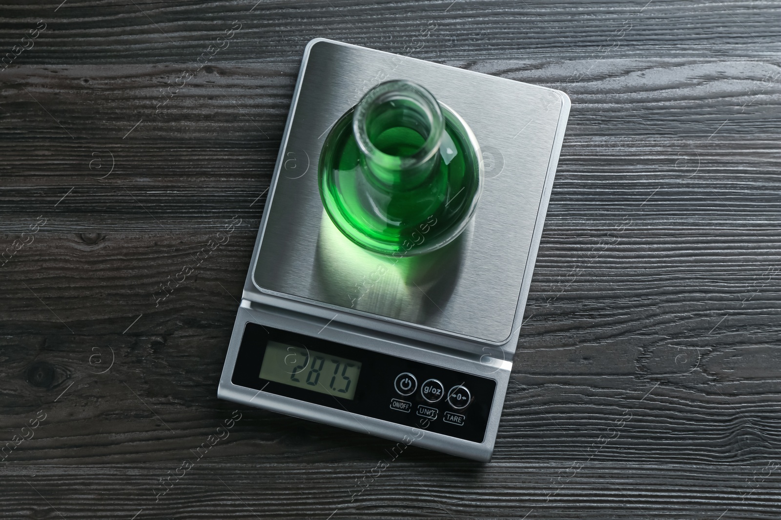 Laboratory scale with flask of sample on wooden table, top view Photo of Laboratory scale with flask of sample on wooden table, top view